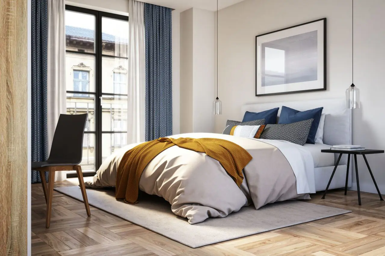 Modern bedroom with large window and decor.