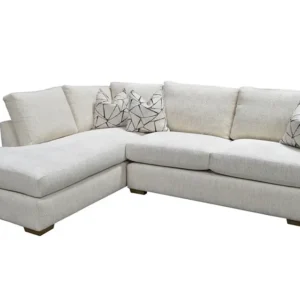 Cream L-shaped sectional sofa with patterned pillows