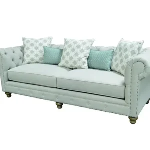 Light blue tufted sofa with patterned pillows