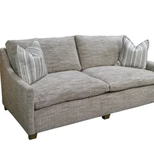 Gray upholstered sofa with striped throw pillows