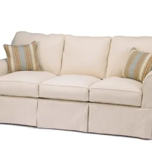 Cream slipcovered sofa with striped pillows
